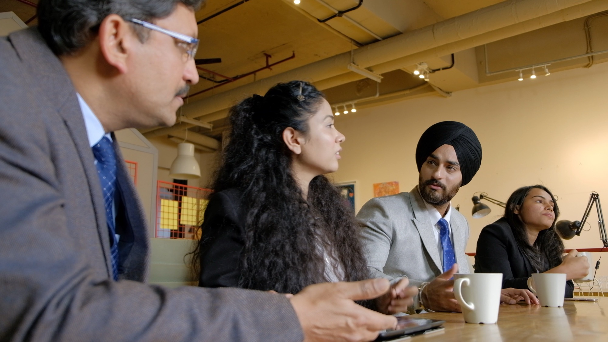 A diverse team of Indian professionals in a corporate meeting discussion